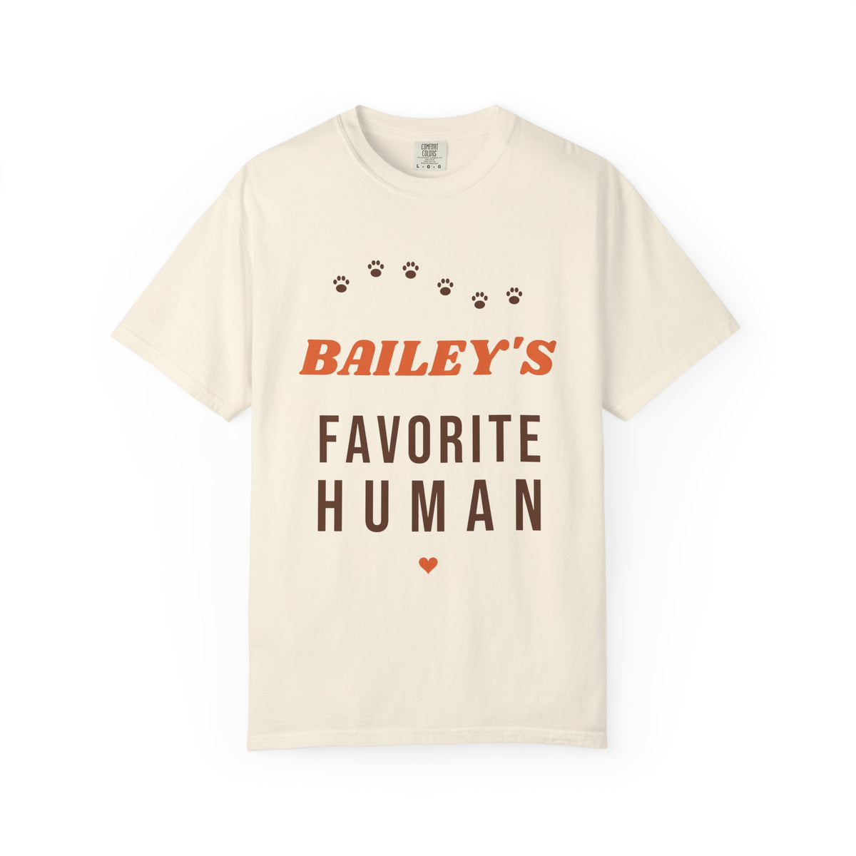 Tee printed with BAILEY'S in orange retro letters over FAVORITE HUMAN with a brown paw print trail